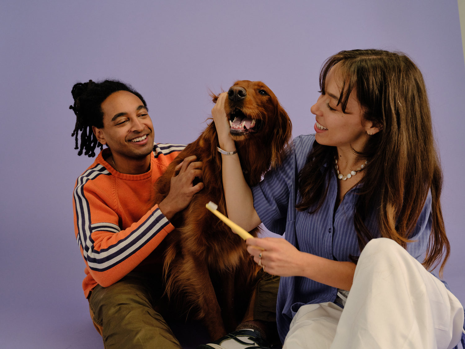 Couple with their dog and an Oreze brush