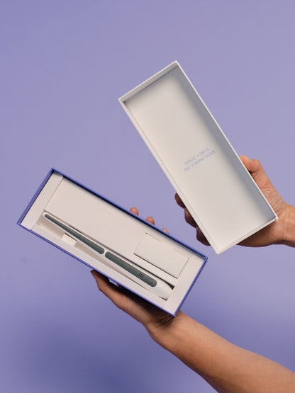 The Oreze brush and charger in the packaging box