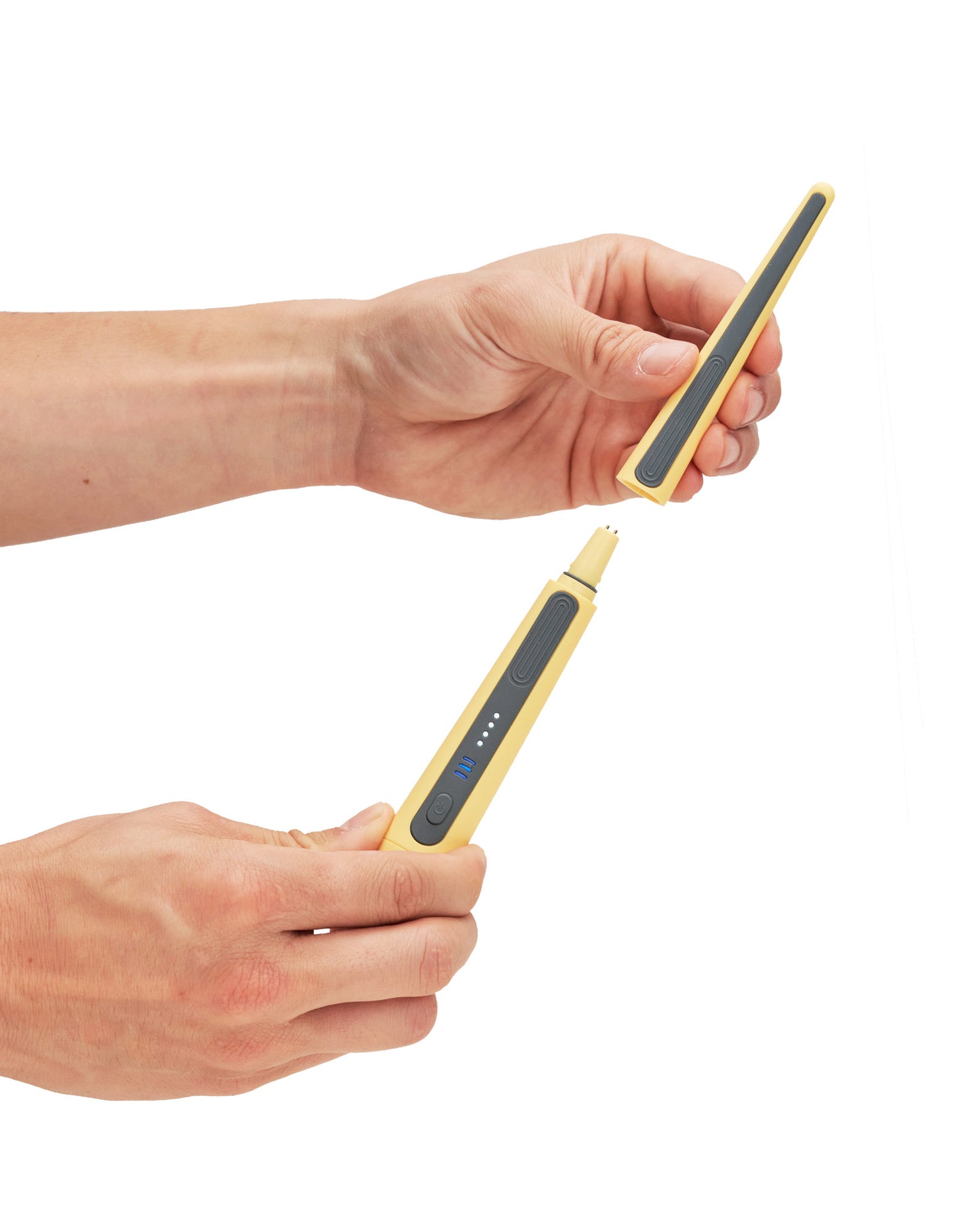 A replacement brush head for the Oreze toothbrush in canary yellow, demonstrated by a model's hands